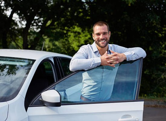Handsome man standing and leaning on car door Handsome man standing and leaning on car door